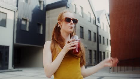 young woman enjoying a smoothie in the city