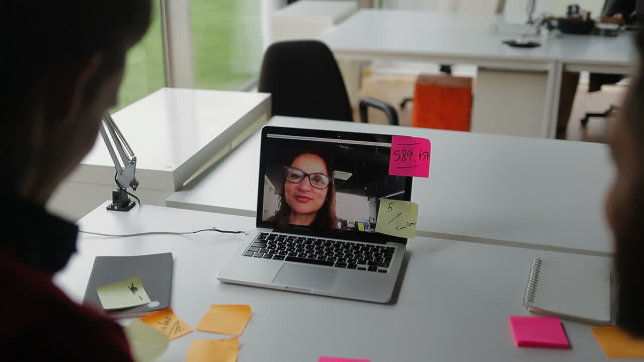 Young business people holding meeting through video call.