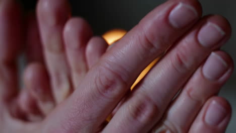hands and feet focused on a candle