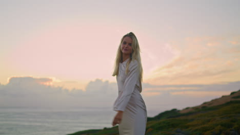 slim lady whirling sea view cliff closeup. woman spinning enjoying marine sunset