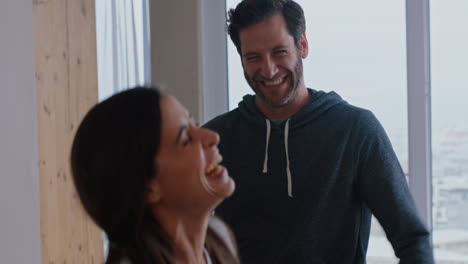 happy young couple dancing at home enjoying successful vacation having fun celebrating lifestyle on holiday with playful dance in living room