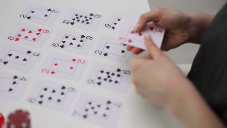 person playing a card game with poker chips and dice