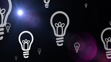 Animation-of-multiple-light-bulb-icons-floating-against-blue-light-spot-on-black-background