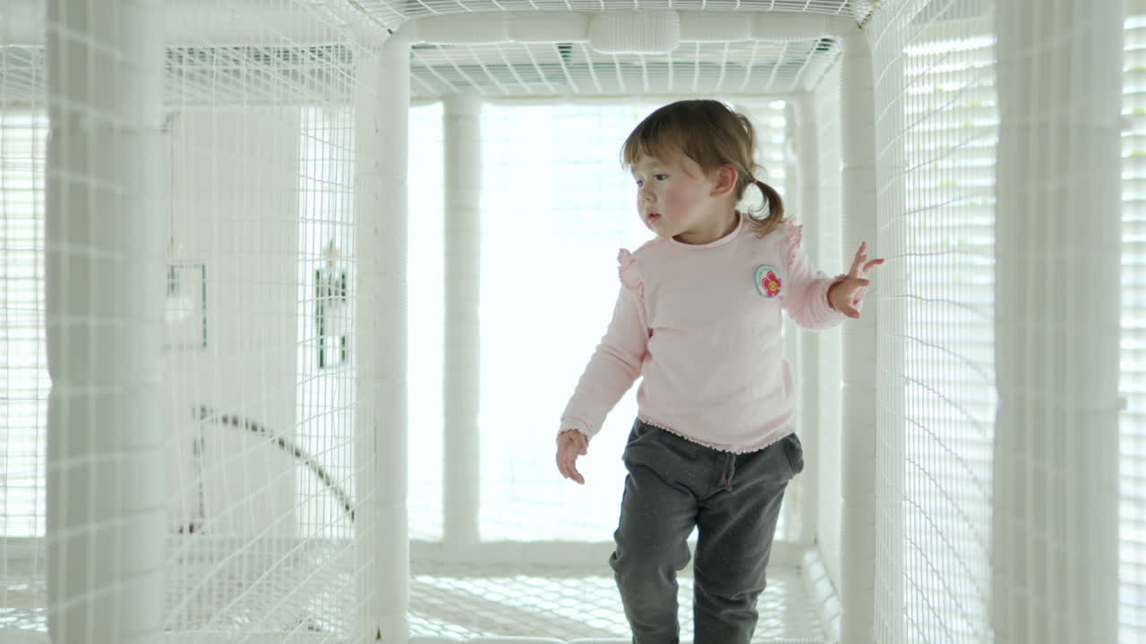 Adorable Little Girl Walking Inside the Rope Maze for Children