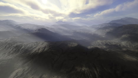 vast mountain landscape under a cloudy sky with soft light in the background