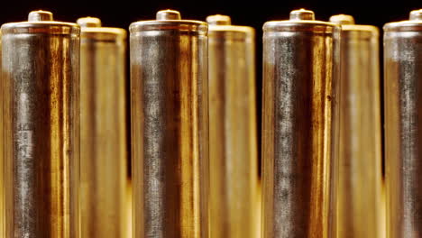 silver batteries aa and aaa in neon light close-up. double-a battery is a standard size single cell cylindrical dry battery. batteries are common in portable electronic devices. an aa battery is composed of a single electrochemical cell that may be either a primary battery or a rechargeable battery.