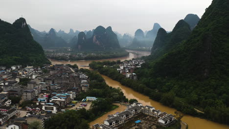 Limestone-peak-scenery,-flying-along-the-Li-River-in-Yangshuo,-China---Aerial-view
