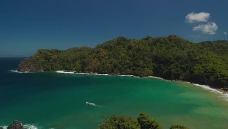 Aerial-birds-eye-view-of-a-fishing-boat-leaving-Englishman's-Bay