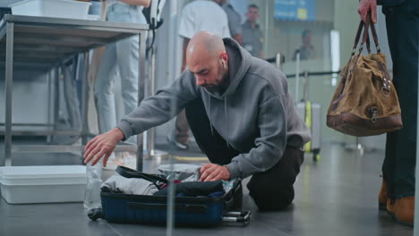 Passenger Checking Suitcase at Airport Security