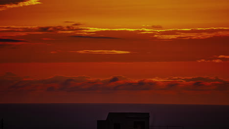 Timelapse-shot-of-majestic-sunset-over-cloudscape-sky-over-the-sea-water