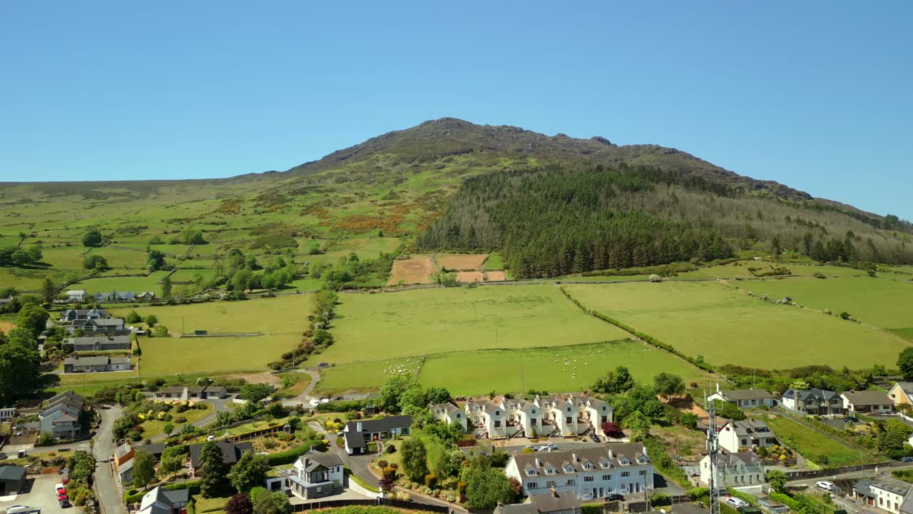 Wide, reversing aerial video of the Cooley Mountains in Carlingford, County Louth, Ireland on a bright and sunny day. Filmed in 4K, 60FPS and with Rec709 color.
