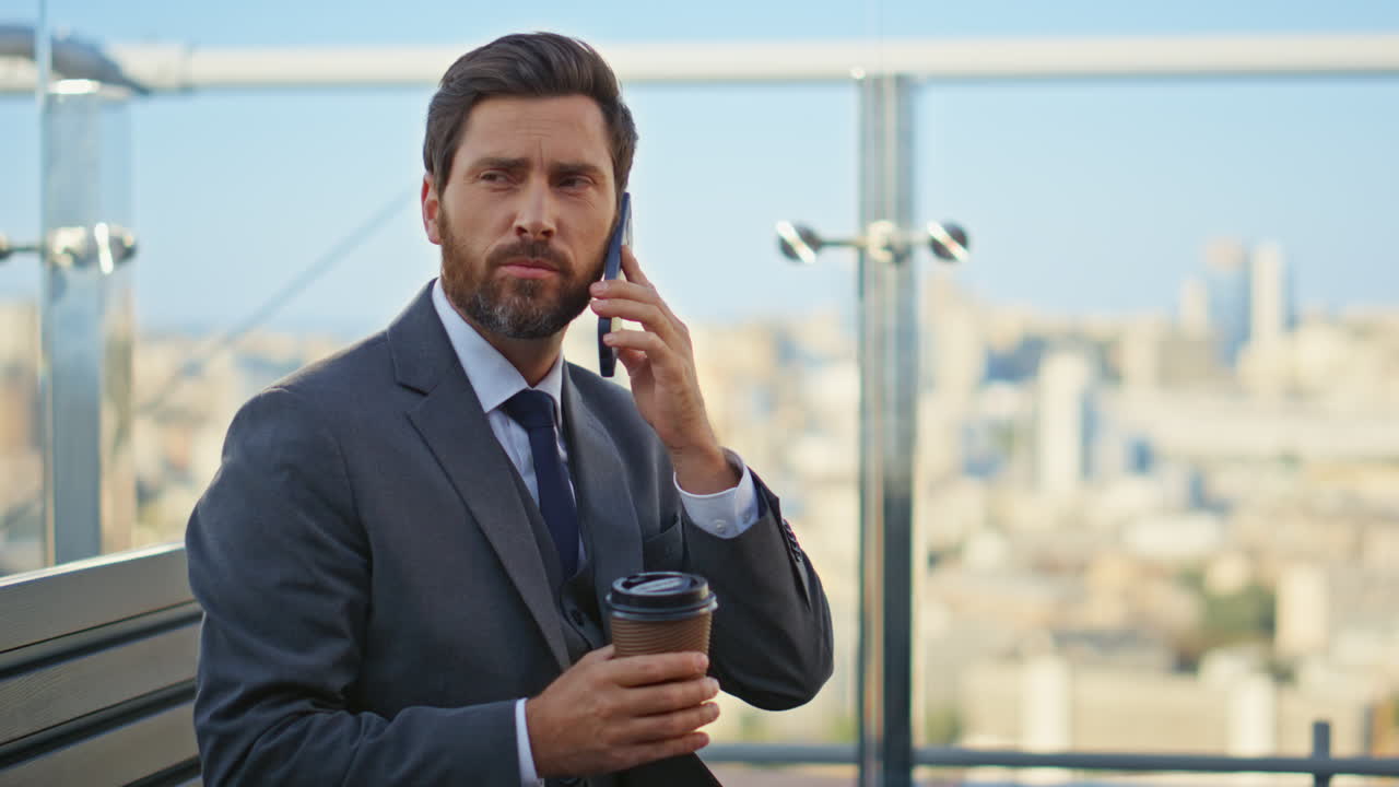 Corporate man speaking cell at cityscape closeup. Businessman sipping coffee