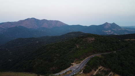 a drone pulls back over a mountain road in pico de los reales in estepona, spain