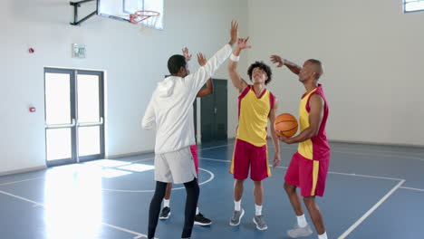 young african american man celebrates with teammates in a gym