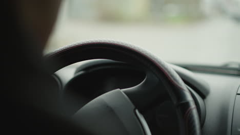 green turn signal indicator blinking and clicking on dashboard as driver navigates busy urban intersection, close focus on illuminated lights and blurred city vehicles passing outside windshield