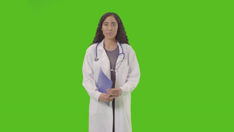 portrait of female doctor in white lab coat with stethoscope against green screen 2