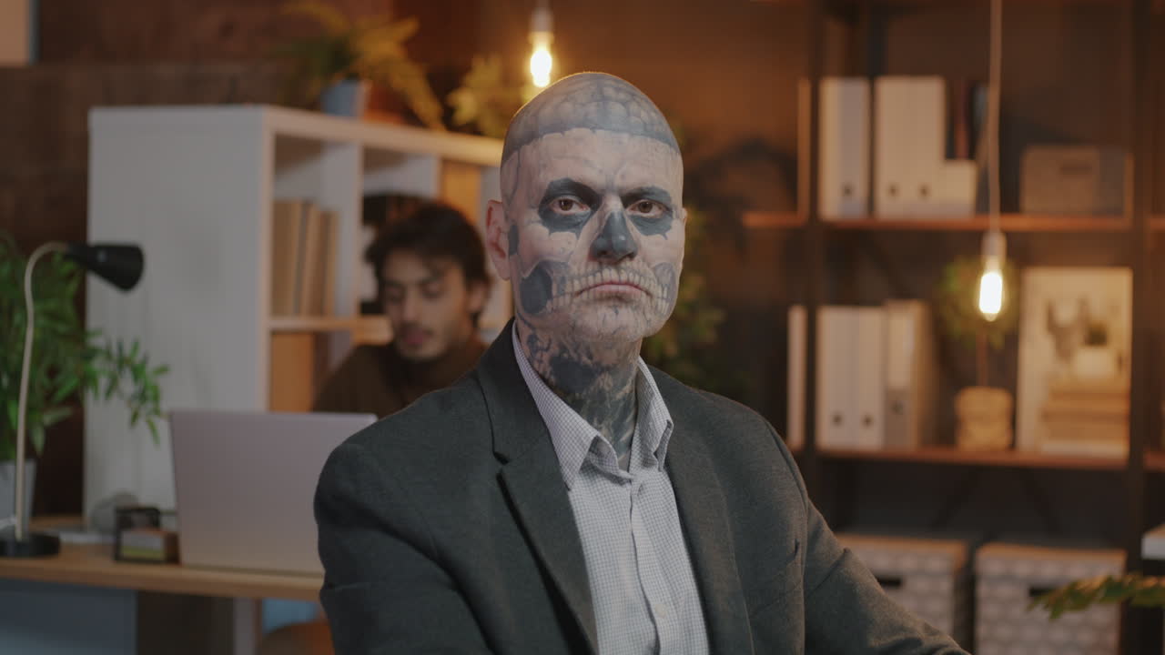 Man with Skull Face Paint in Office