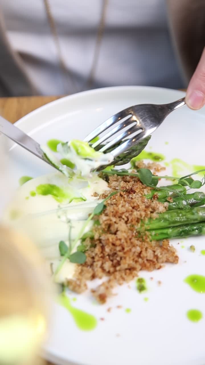 Close-up of a Person Eating Gourmet Asparagus Dish