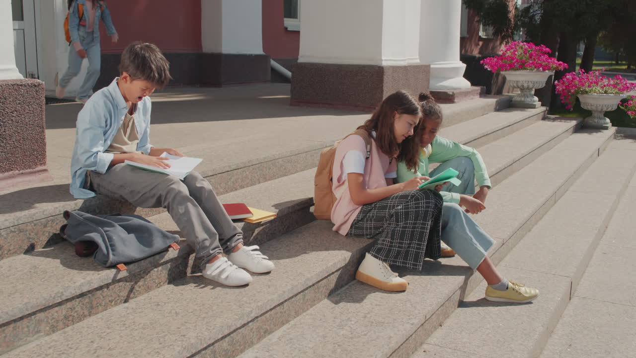 Group of Children Sitting on Steps of Middle School