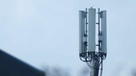 cellular telecommunication transmission tower on gloomy overcast morning close up