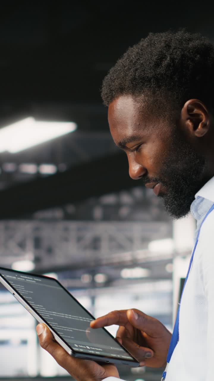 Vertical video Data center programmer checking lines of code next to colleague
