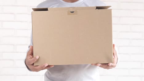 person holding a cardboard box