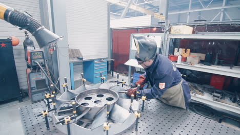 welding process in workshop of manual metalworking. factory worker making weld