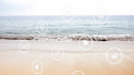 ocean waves rolling onto beach with animation of digital icons overlayed