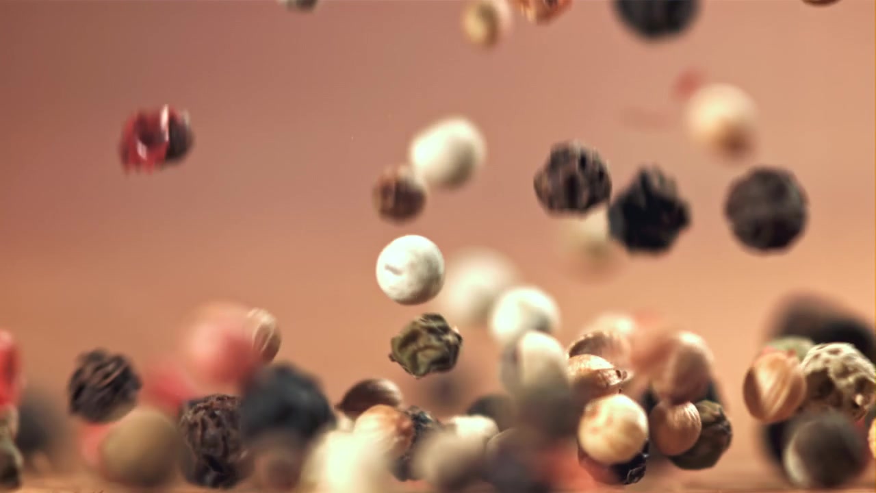 Mixed Peppercorns Falling and Bouncing in Slow Motion