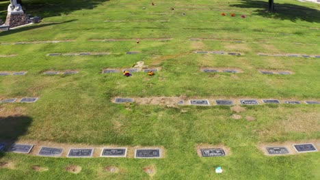 low aerial shot flying over headstones in the lawn of a california mortuary