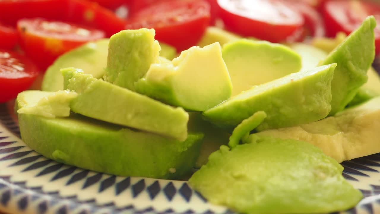 Sliced Avocado and Tomatoes on a Plate