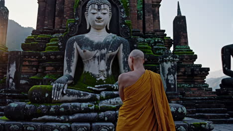 monk at a buddhist temple in thailand