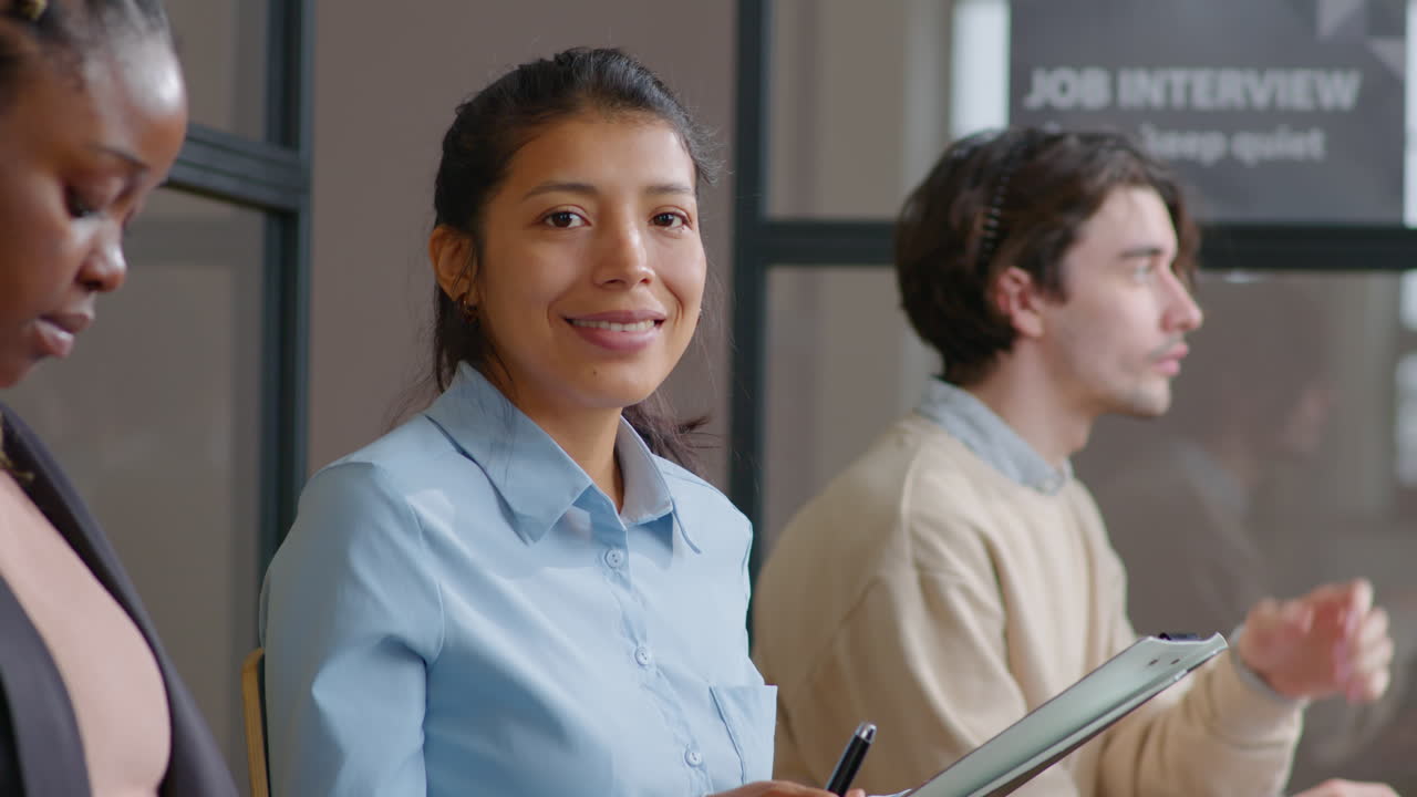 Portrait of Smiling Hispanic Woman Waiting for Job Interview