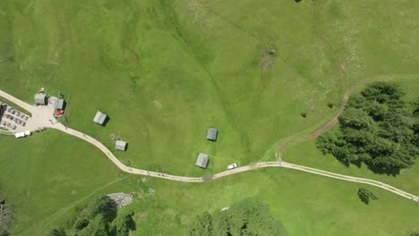 An-aerial-view-captures-the-Utaia-da-Rit-mountain-hut-near-La-Val-village-in-the-Dolomites,-Italy