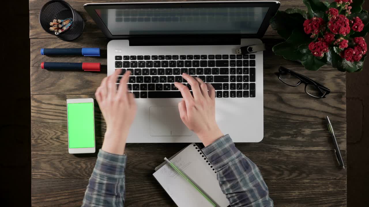Top view of wooden table with office supplies.