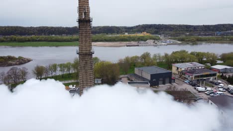 flyby shot through the smoke of industrial power plant chimney