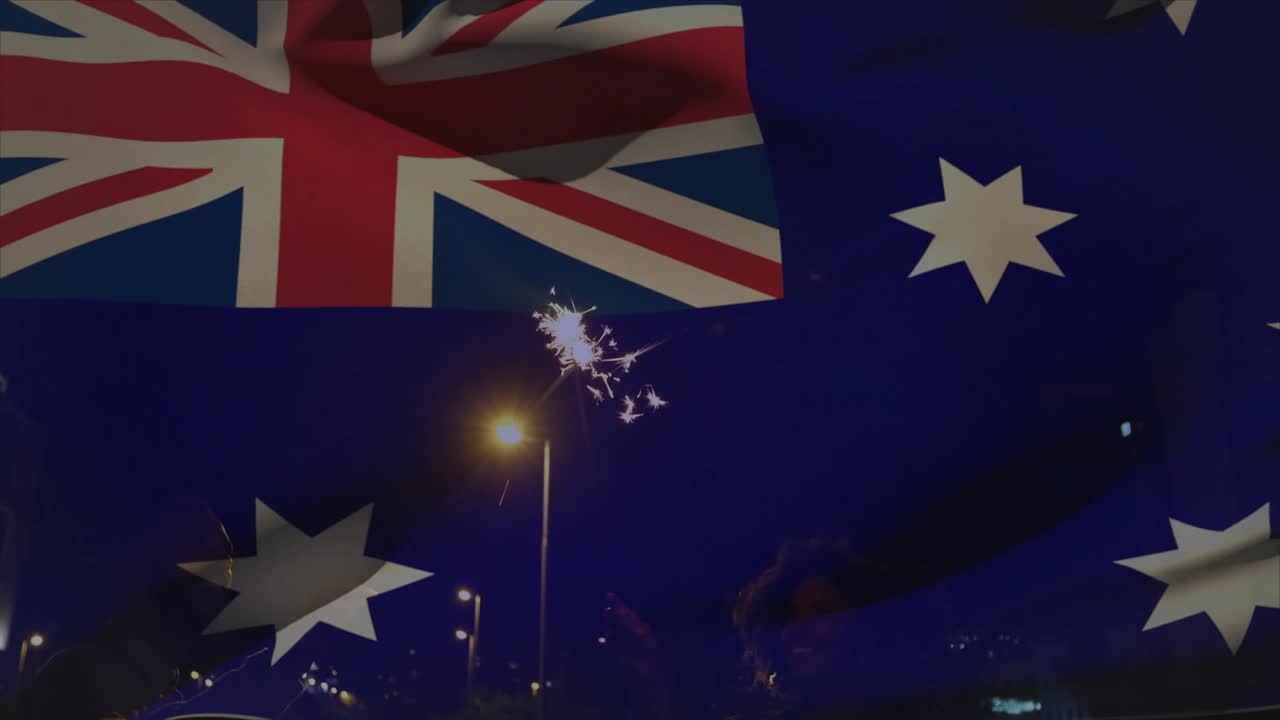 Woman, man waving sparkler on balcony, spark igniting Aussie flag graphic rippling, celebrating ads