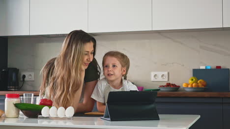 daughter consults mother in kitchen