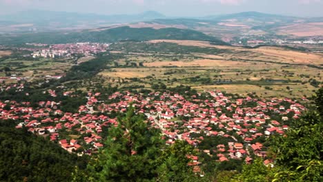 view of a small town from a mountain on a sunny summer day