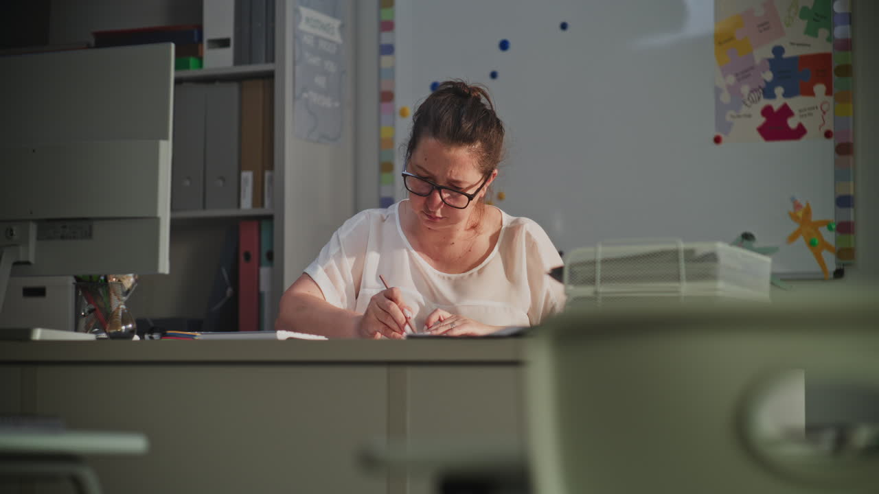 Female Teacher Checking Homework of Students Grading School Tests After Class