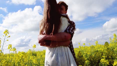 Romantic-couple-embracing-each-other-in-mustard-field