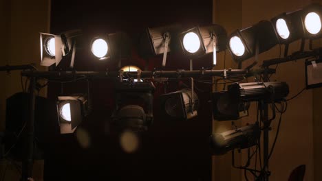 revealing shot with theater stage lights, white light, handheld