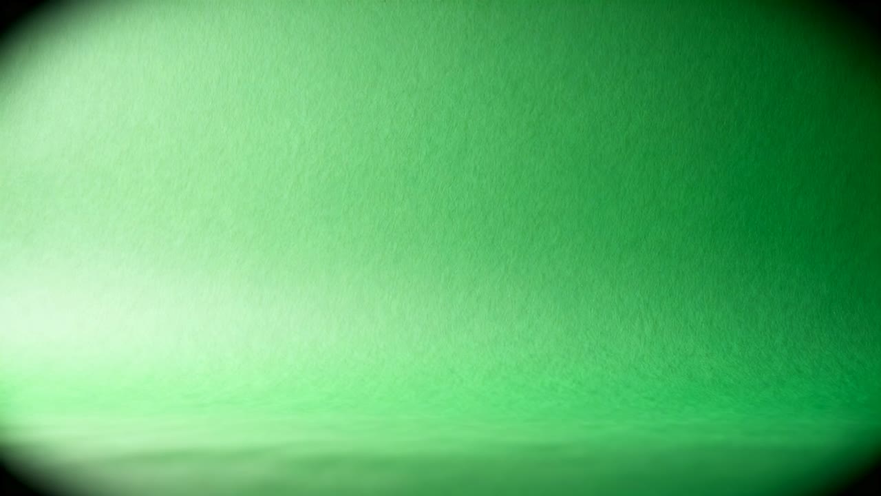 Recording with camera fixed, textured green backdrop filling studio close-up, showing lens vignette