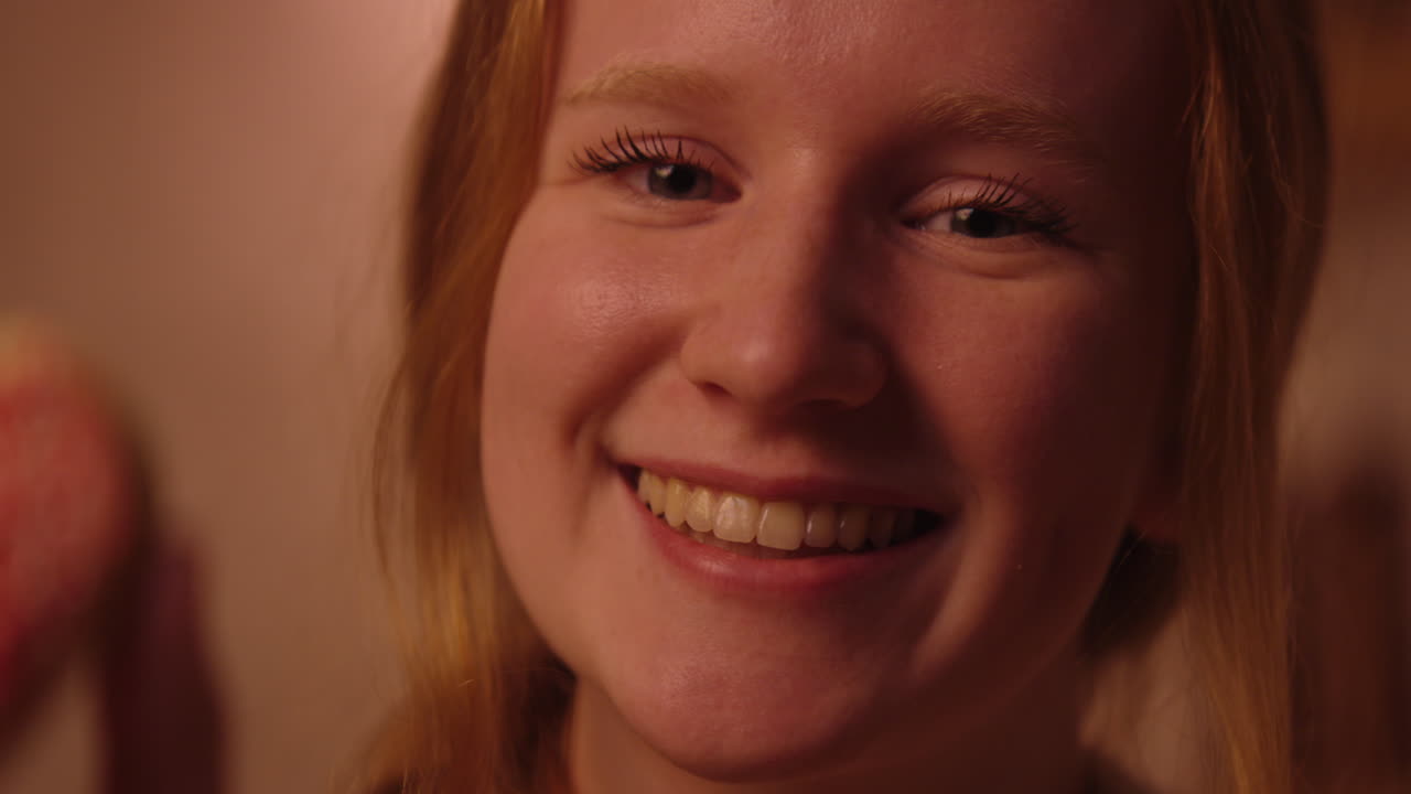 Happy Girl Holding a Heart-Shaped Cookie