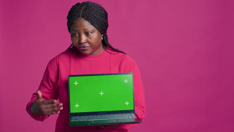 Lady-Holds-Laptop-With-Chromakey-Display