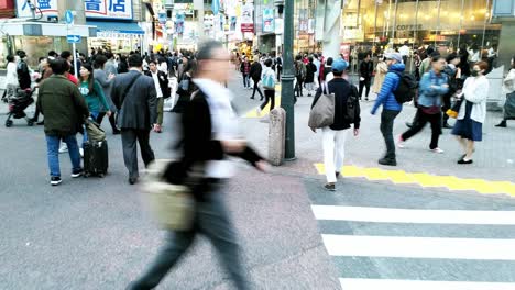 point of view of japanese pedestrian walking across the shibuya town square crosswalk during the rush hour in midday, in shibuya, tokyo, japan. gimbal steady cam