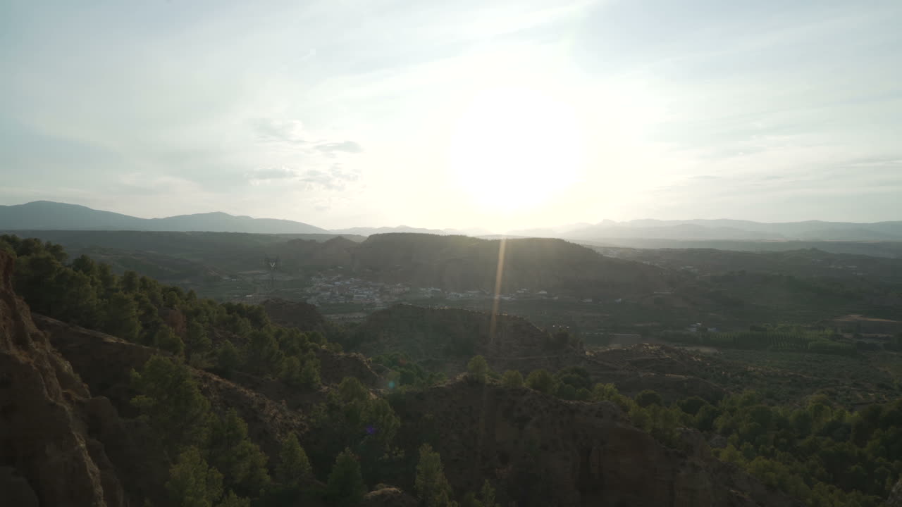 Woman in Dress Watching Sunset over Mountains