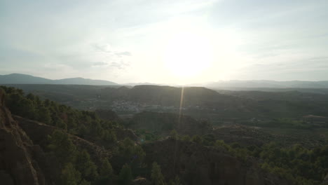 Woman in Dress Watching Sunset over Mountains