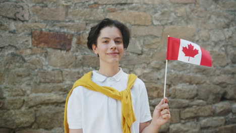teenager holding canadian flag