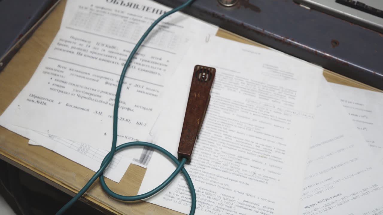 Antique Microphone Sits On The Documents In The Table. - high angle shot